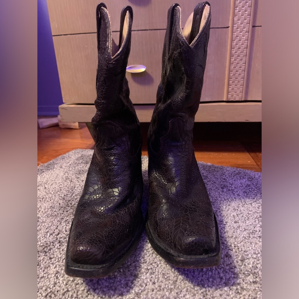 Women’s brown leather cowboy boots.